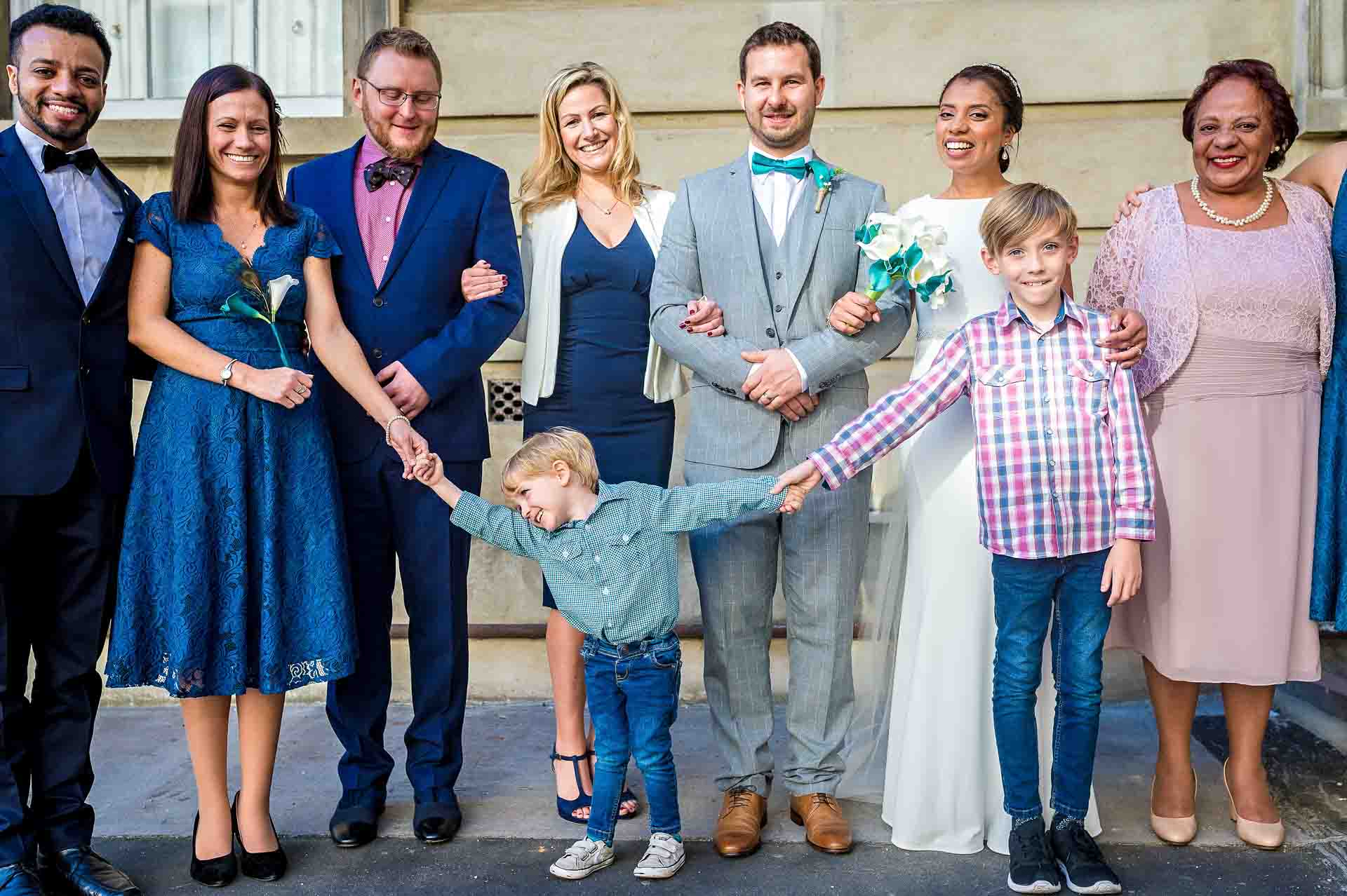Posed Group Wedding Photograph with Little Boys Holding Hands