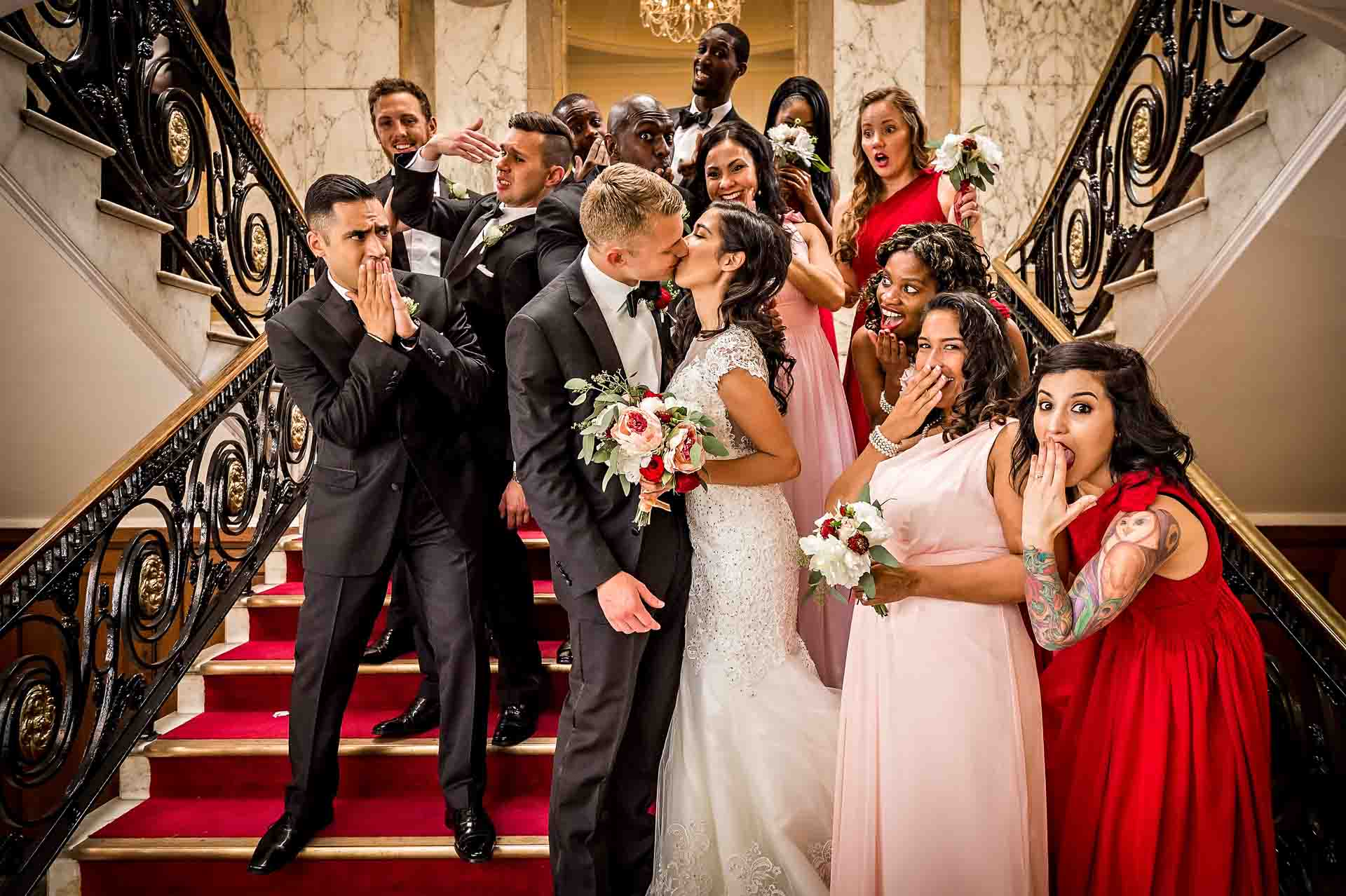 Bride and Groom Kissing with Other Guests Watching Horrified
